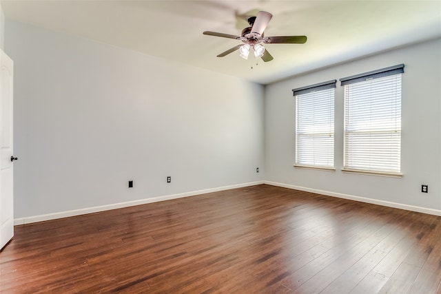 spare room with ceiling fan and dark wood-type flooring