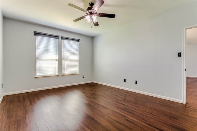 unfurnished room with ceiling fan and dark wood-type flooring