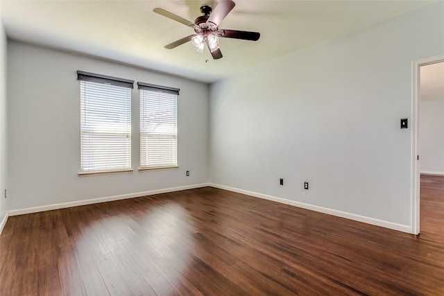 spare room featuring ceiling fan and dark hardwood / wood-style flooring