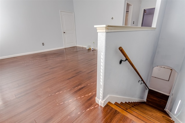 stairway with hardwood / wood-style flooring