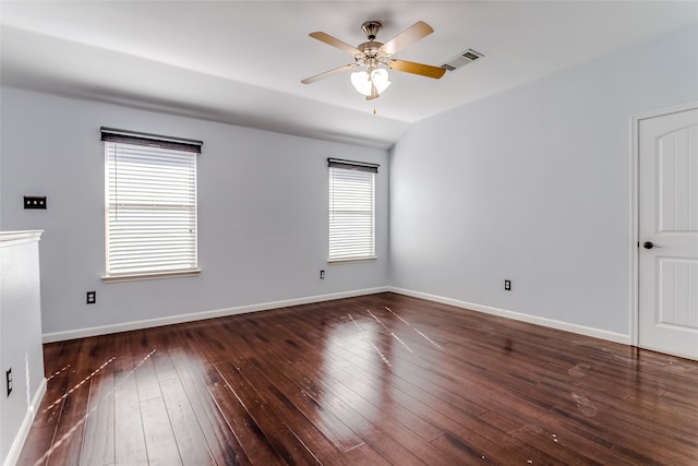 spare room with ceiling fan, dark wood-type flooring, and a healthy amount of sunlight