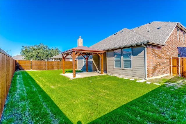 back of house with a gazebo, a patio area, and a lawn