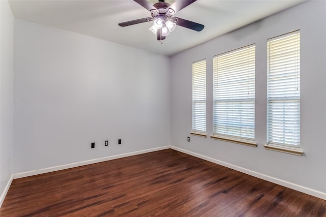 unfurnished room with ceiling fan and dark hardwood / wood-style flooring