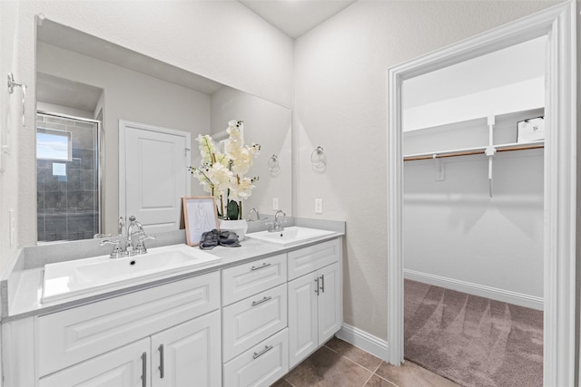 bathroom featuring tile patterned flooring, vanity, and an enclosed shower