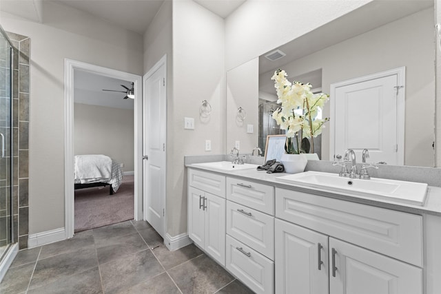 bathroom with tile patterned floors, ceiling fan, an enclosed shower, and vanity