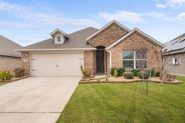 view of front of house with a front yard and a garage