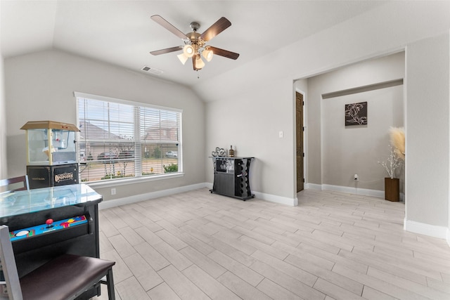 interior space featuring ceiling fan, lofted ceiling, and light wood-type flooring