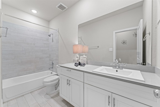 full bathroom with vanity, toilet, and tiled shower / bath combo