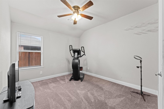 workout room featuring ceiling fan, lofted ceiling, and light carpet