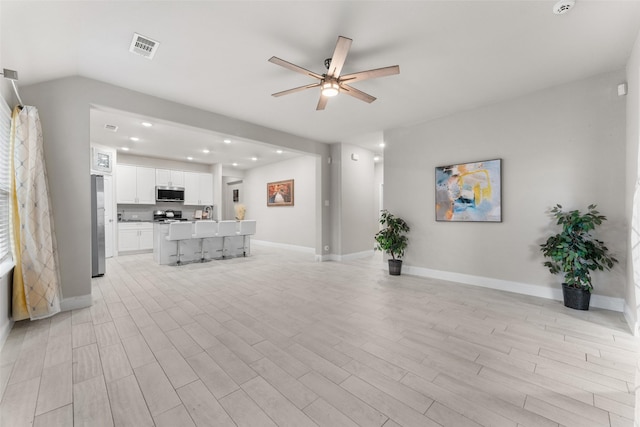 unfurnished living room featuring light hardwood / wood-style floors and ceiling fan