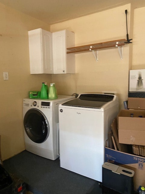 laundry area featuring cabinets, sink, and washer and dryer