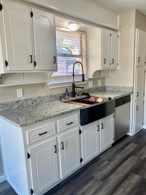 kitchen with dishwasher, white cabinetry, and a textured ceiling