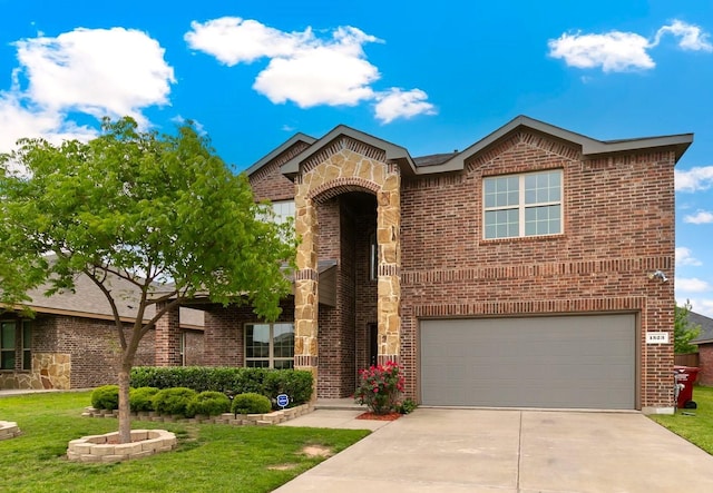 view of front of property featuring a garage and a front yard