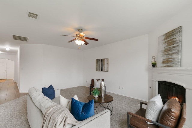 living room with ceiling fan and carpet flooring