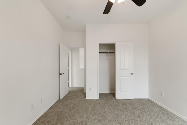 unfurnished bedroom featuring light carpet, ceiling fan, and a closet