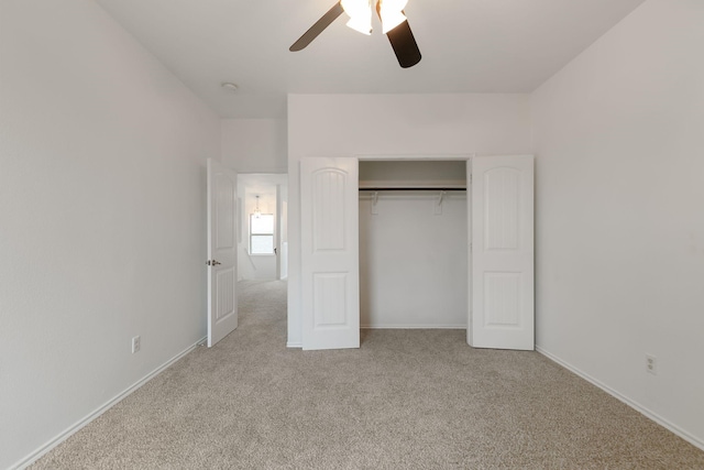 unfurnished bedroom with ceiling fan, a closet, and light colored carpet