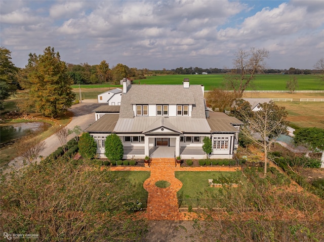 view of front of home featuring a front yard and a rural view