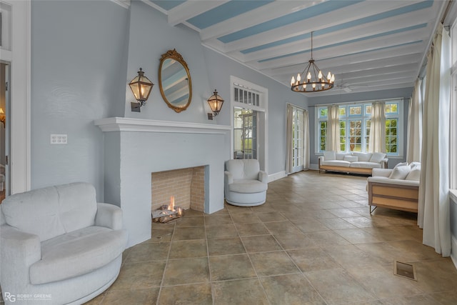 interior space featuring beamed ceiling, tile patterned floors, a wealth of natural light, and a notable chandelier