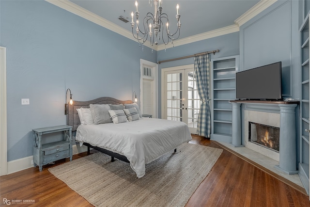 bedroom featuring wood-type flooring, an inviting chandelier, french doors, and crown molding