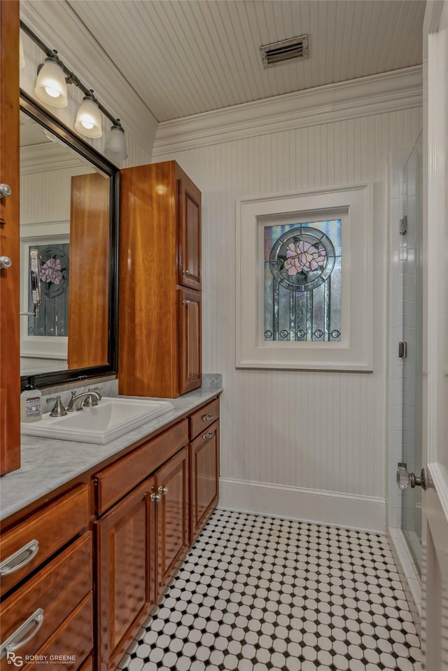 bathroom featuring crown molding, vanity, and walk in shower