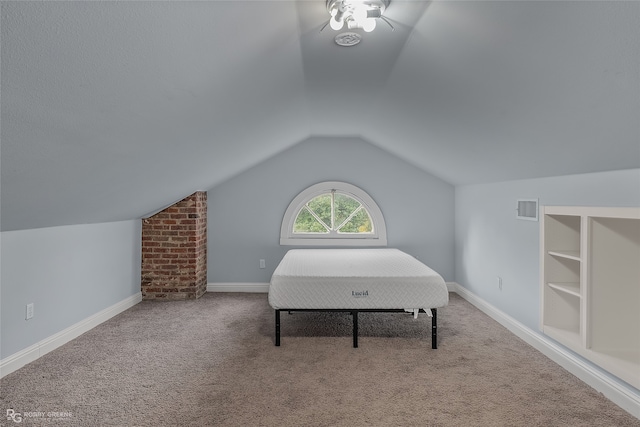 bedroom featuring carpet and vaulted ceiling