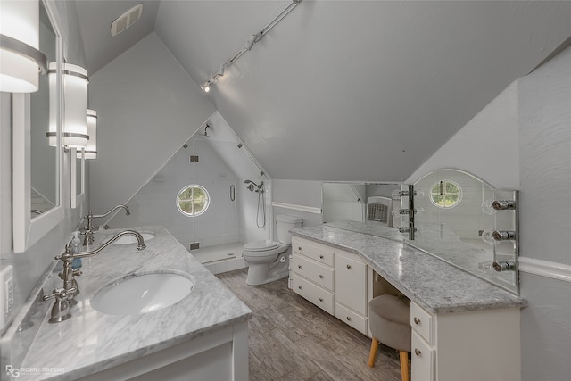 bathroom featuring vanity, toilet, vaulted ceiling, and hardwood / wood-style floors