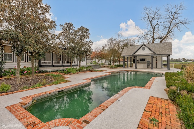 view of swimming pool featuring a patio area and an outdoor structure