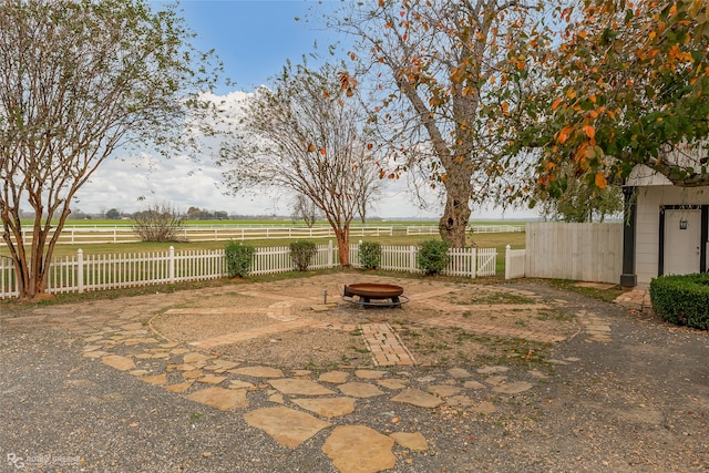 view of yard with a rural view and an outdoor fire pit