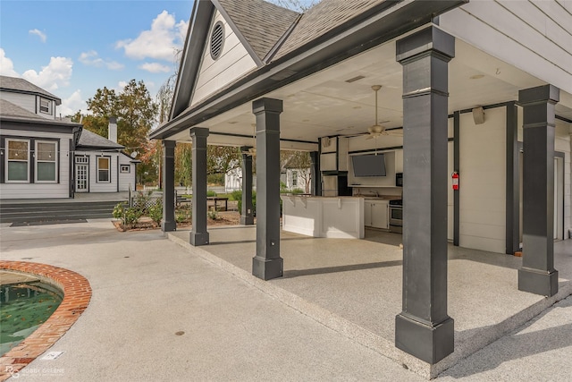 view of patio with ceiling fan and exterior kitchen