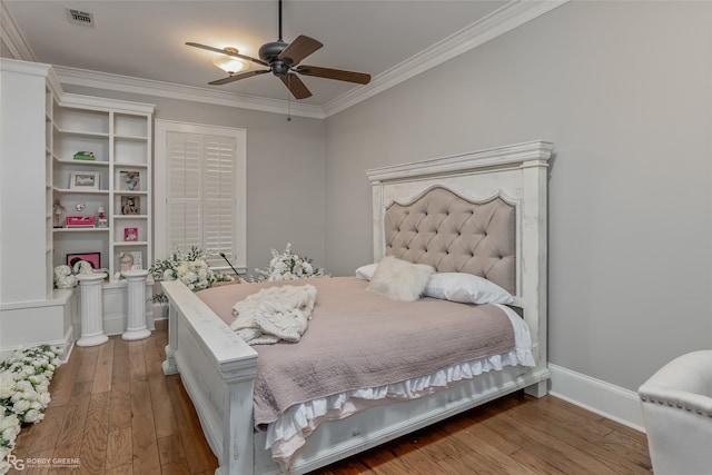 bedroom featuring hardwood / wood-style flooring, ceiling fan, and crown molding