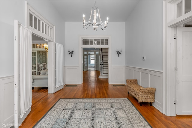 interior space with wood-type flooring and a chandelier