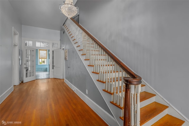 entrance foyer featuring wood-type flooring and an inviting chandelier