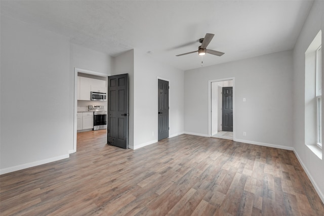 unfurnished bedroom with light hardwood / wood-style floors and ceiling fan