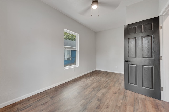 unfurnished room with hardwood / wood-style flooring and ceiling fan