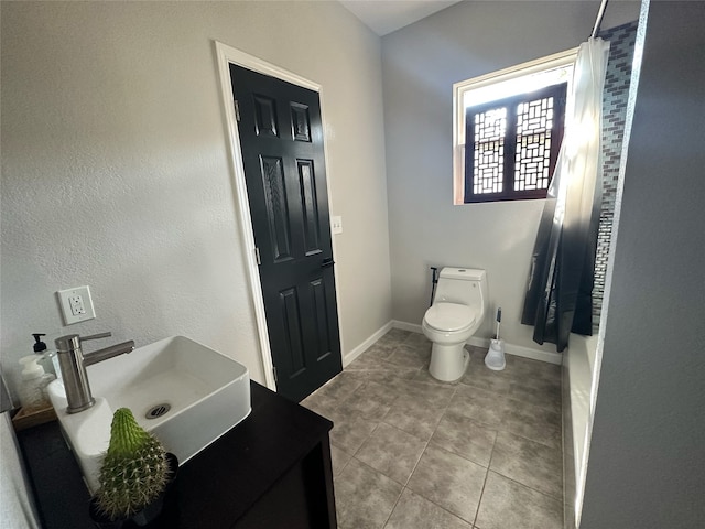 bathroom featuring tile patterned floors, sink, a shower with shower curtain, and toilet