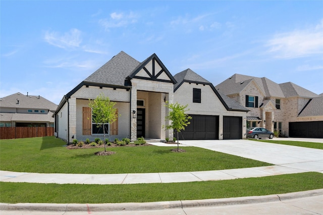 view of front of house featuring driveway, a garage, brick siding, fence, and a front lawn