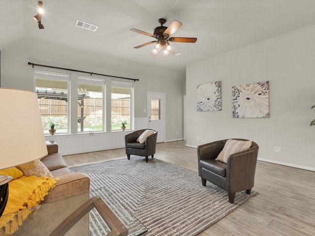 living room with ceiling fan and light hardwood / wood-style flooring