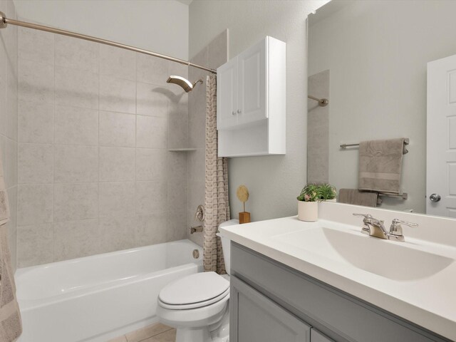 full bathroom with toilet, shower / bath combination with curtain, tile patterned floors, and vanity