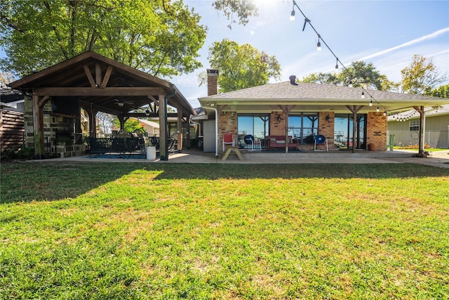 rear view of house with a yard and a patio