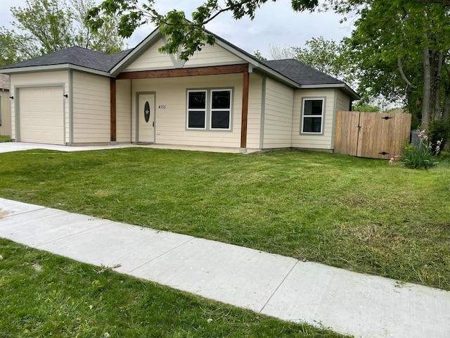 view of front facade featuring a front lawn, a gate, fence, a garage, and a shingled roof