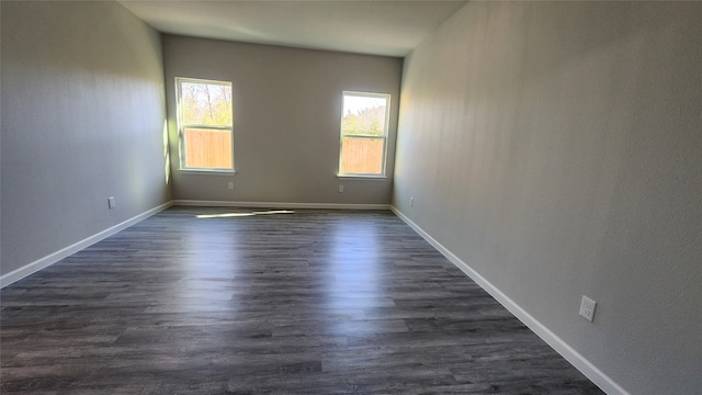 spare room with dark hardwood / wood-style floors