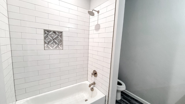 full bathroom featuring wood finished floors, toilet, baseboards, and  shower combination