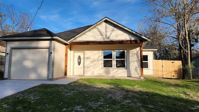 view of front of property featuring a garage and a front yard