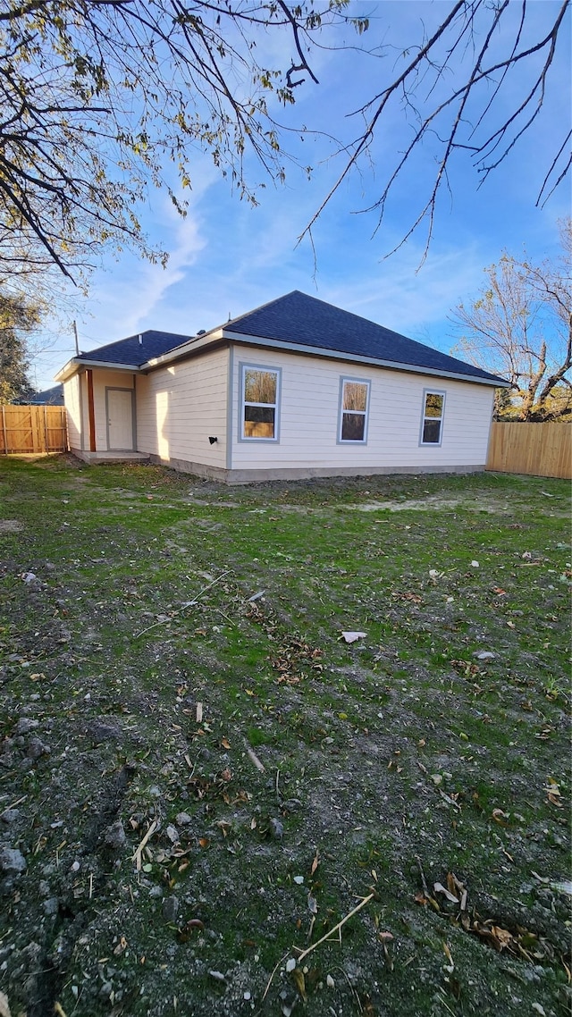 view of side of home with a lawn