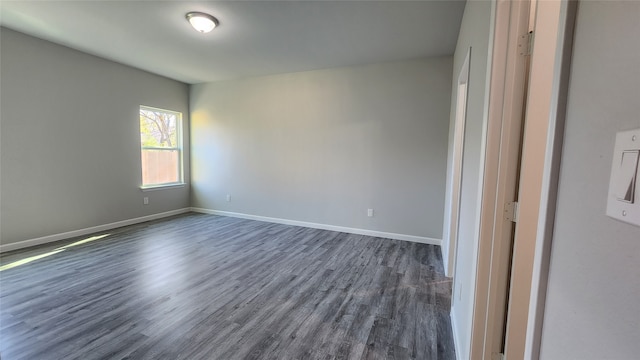 spare room featuring dark hardwood / wood-style floors