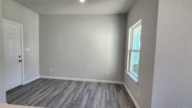 empty room with wood-type flooring and a wealth of natural light