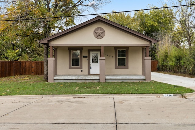 bungalow with a porch and a front lawn