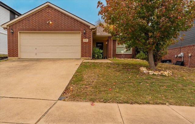 view of front of property featuring a garage and a front lawn