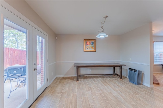 dining area featuring plenty of natural light, light hardwood / wood-style floors, and french doors