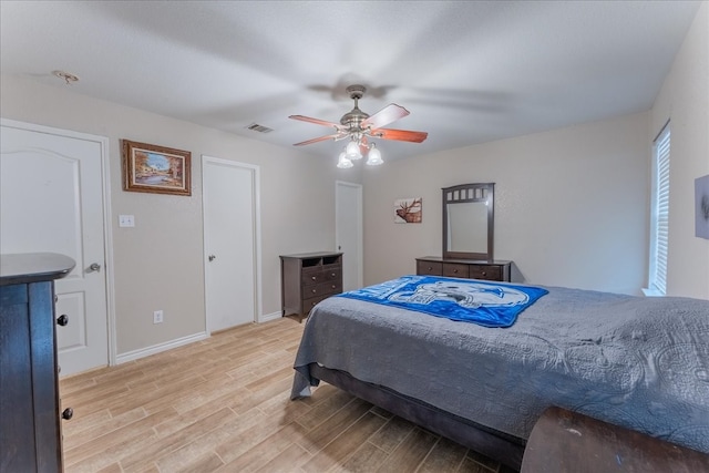 bedroom with ceiling fan and light hardwood / wood-style floors